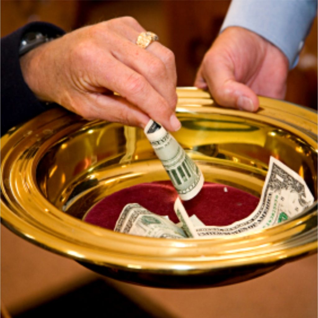 Hands donating funds into offering plate